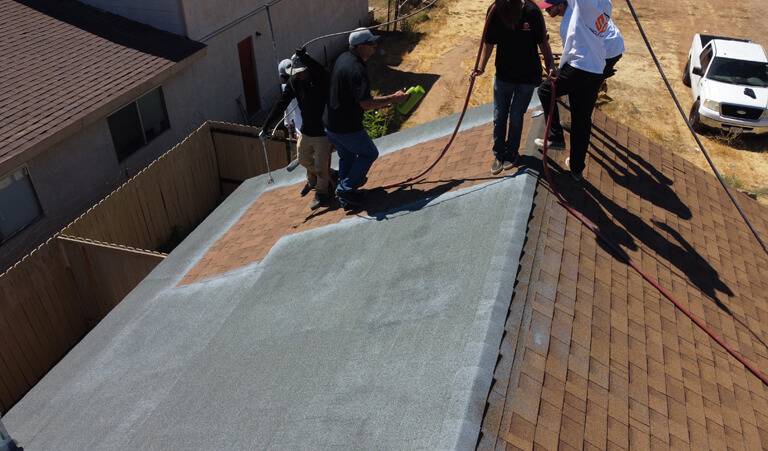 A group of some people standing on top of a roof.