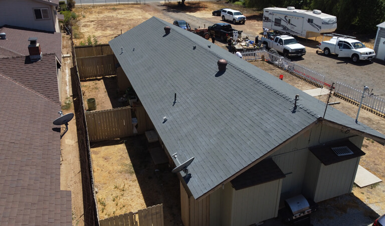 A view of a building from above with the roof being installed.