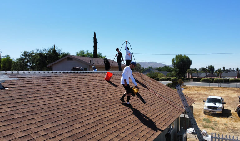 A group of people standing on top of a roof.