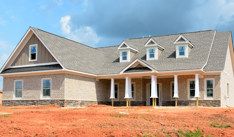 A large house with a lot of windows and a porch.