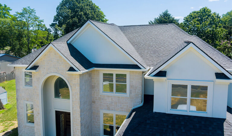 A house with a black roof and white walls