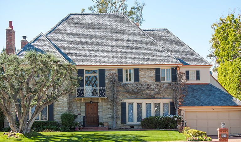 A large house with a blue door and windows.