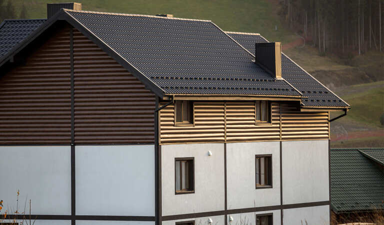 A building with a black roof and white walls.